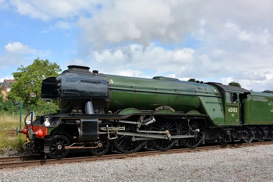 Flying Scotsman, a large green steam locomotive, outdoors beside a platform