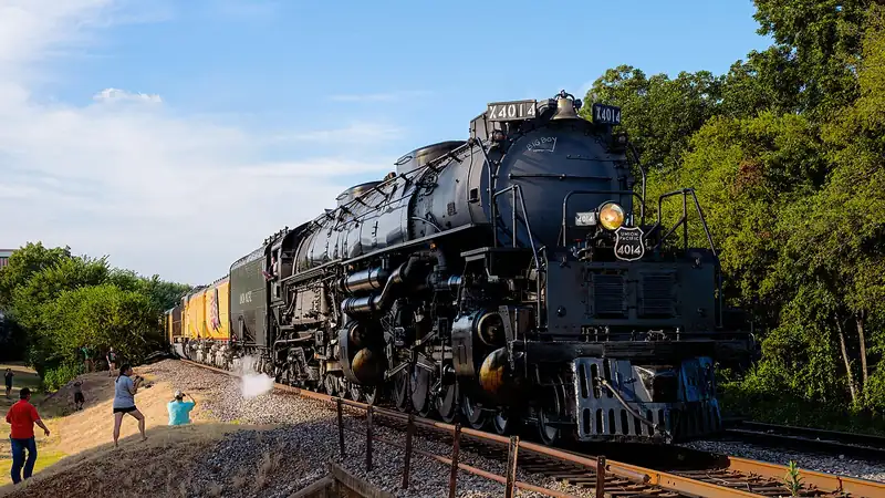 Union Pacific Big Boy 4014, a huge black steam locomotive, pulling a train outdoors